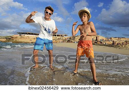 Stock Photo - "Two boys rapping on the beach in front of Cala Comte, Platges de Comte, Ibiza, Pitiusic Islands or Pine Islands, Balearic Islands, Spain, Europe". Fotosearch