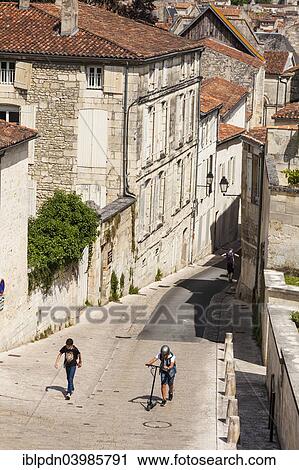 "Two boys walking up the steep hill of Rue des Jacobins, Saintes, Poitou-Charentes, France, Europe" View Large Photo Image Stock Image - "Two boys walking up the steep hill of Rue des Jacobins, Saintes, Poitou-Charentes, France, Europe". Fotosearch
