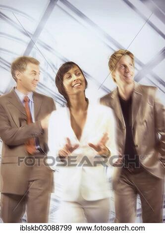 Two businessmen with a businesswoman in the middle View Large Photo Image Stock Photo - Two businessmen with a businesswoman in the middle. Fotosearch