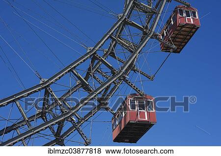 Stock Photo - "Two cabins of the Wiener Riesenrad ferris wheel against a blue sky at the Prater, Vienna, Austria, Europe". Fotosearch