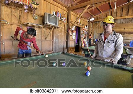 "Two Cambodian youths playing pool billiards in a simple wooden hut, Banlung, Ratanakiri Province, Cambodia, Asia" View Large Photo Image Stock Image - "Two Cambodian youths playing pool billiards in a simple wooden hut, Banlung, Ratanakiri Province, Cambodia, Asia". Fotosearch