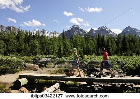 Stock Photo - "Two children crossing a bridge in the Rocky Mountains, Banff National Park, Alberta Province, Canada, North America". Fotosearch