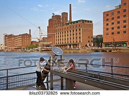 "Two children playing at a water feature in the inner harbour, Duisburg, Ruhr district, North Rhine-Westphalia, Germany, Europe" View Large Photo Image Stock Photography - "Two children playing at a water feature in the inner harbour, Duisburg, Ruhr district, North Rhine-Westphalia, Germany, Europe". Fotosearch