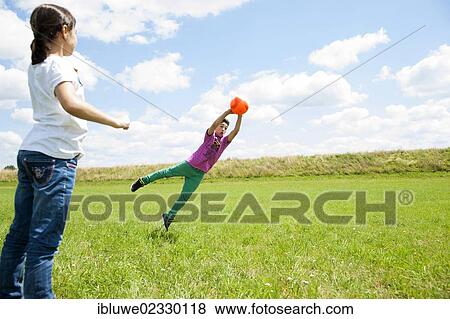 Two children practicing goalkeeper training on a meadow View Large Photo Image Stock Photo - Two children practicing goalkeeper training on a meadow. Fotosearch