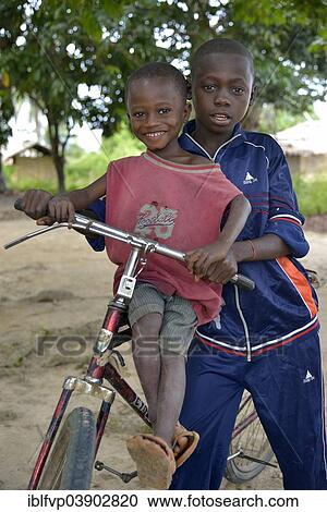 "Two children with a bicycle, Nkala, Bandundu Province, Democratic Republic of the Congo" View Large Photo Image Stock Image - "Two children with a bicycle, Nkala, Bandundu Province, Democratic Republic of the Congo". Fotosearch