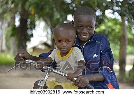 "Two children with a bicycle, Nkala, Bandundu Province, Democratic Republic of the Congo" View Large Photo Image Stock Photograph - "Two children with a bicycle, Nkala, Bandundu Province, Democratic Republic of the Congo". Fotosearch