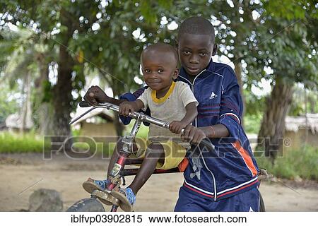"Two children with a bicycle, Nkala, Bandundu Province, Democratic Republic of the Congo" View Large Photo Image Stock Photography - "Two children with a bicycle, Nkala, Bandundu Province, Democratic Republic of the Congo". Fotosearch