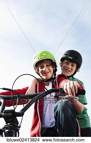 Two cool boys on a BMX bike View Large Photo Image Picture - Two cool boys on a BMX bike. Fotosearch