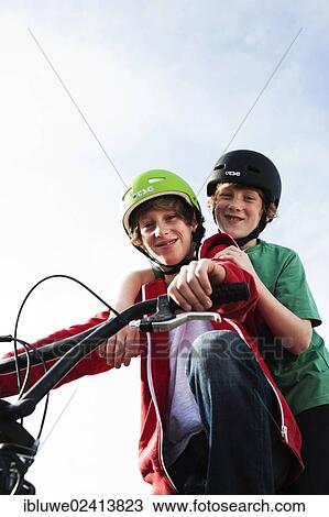 Two cool boys on a BMX bike View Large Photo Image Stock Image - Two cool boys on a BMX bike. Fotosearch