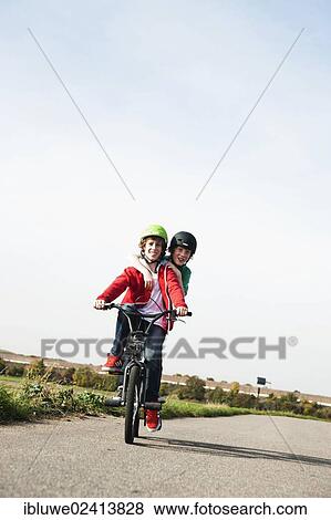 Two cool boys on a BMX bike View Large Photo Image Stock Photo - Two cool boys on a BMX bike. Fotosearch