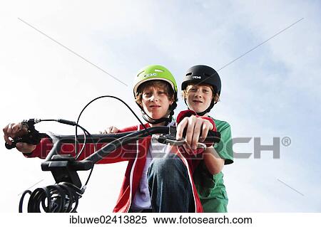Two cool boys on a BMX bike View Large Photo Image Stock Photography - Two cool boys on a BMX bike. Fotosearch