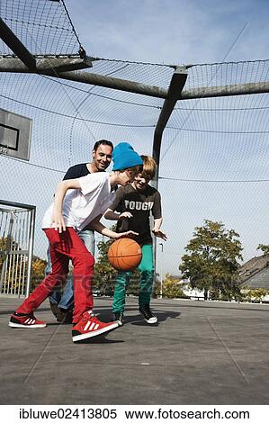 Two cool boys playing basketball with their father View Large Photo Image Stock Photography - Two cool boys playing basketball with their father. Fotosearch