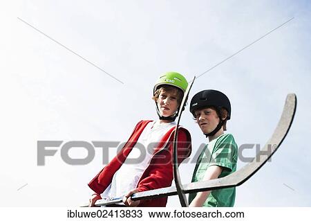 Two cool boys playing roller hockey with hockey sticks View Large Photo Image Stock Image - Two cool boys playing roller hockey with hockey sticks. Fotosearch