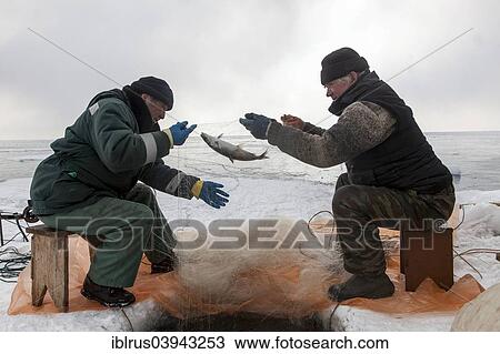 Stock Image - "Two elderly fishermen fishing on the frozen Lake Baikal, Bolschoje Goloustnoje, Lake Baikal Region, Siberia, Russia, Europe". Fotosearch