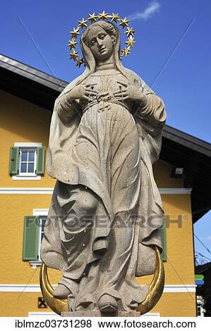 Stock Photo - "Two-faced sculpture, here looking down towards the ground, Mary's Well, 17th century, Grossgmain, Salzburg State, Austria, Europe". Fotosearch
