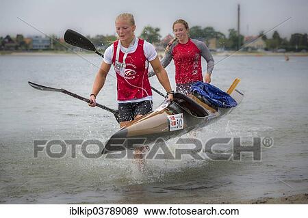 "Two female kayakers carrying a kayak, Copenhagen Beach Marathon for Kayak and Canoe 2013, Copenhagen, Capital region, Denmark, Europe" View Large Photo Image Stock Photo - "Two female kayakers carrying a kayak, Copenhagen Beach Marathon for Kayak and Canoe 2013, Copenhagen, Capital region, Denmark, Europe". Fotosearch