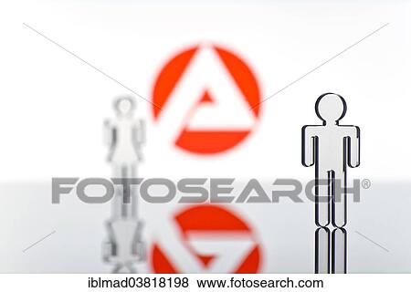 Stock Photo - "Two figures standing in front of the logo of the German employment agency, symbolic picture for unemployment". Fotosearch