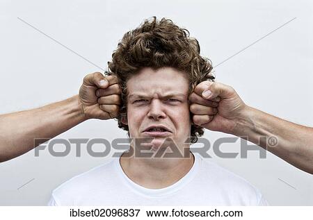 "Two fists attacking the head of a young man, symbolic image for bullying, pain" View Large Photo Image Stock Photo - "Two fists attacking the head of a young man, symbolic image for bullying, pain". Fotosearch