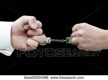 "Two fists connected with small handcuffs, symbolic image for wedding, marriage" View Large Photo Image Stock Photograph - "Two fists connected with small handcuffs, symbolic image for wedding, marriage". Fotosearch