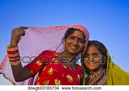 "Two friendly Indian girls with colorful head scarves and jewellery, portrait, Pushkar, Rajasthan, India, Asia" View Large Photo Image Picture - "Two friendly Indian girls with colorful head scarves and jewellery, portrait, Pushkar, Rajasthan, India, Asia". Fotosearch