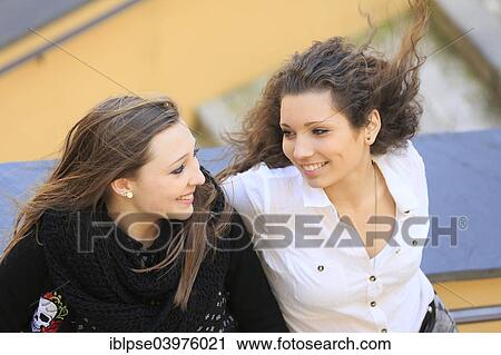 "Two girlfriends, teenagers, leaning against the railing of a staircase, smiling at each other, Menton, Alpes-Maritimes, Provence-Alpes-Cote d'Azur, France, Europe" View Large Photo Image Stock Image - "Two girlfriends, teenagers, leaning against the railing of a staircase, smiling at each other, Menton, Alpes-Maritimes, Provence-Alpes-Cote d'Azur, France, Europe". Fotosearch