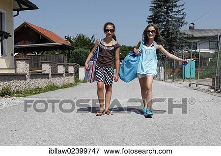 "Two girls, 11, carrying large bags, Austria, Europe" View Large Photo Image Stock Photo - "Two girls, 11, carrying large bags, Austria, Europe". Fotosearch