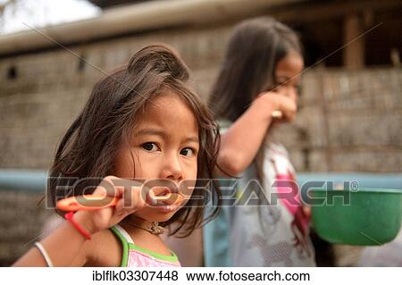 "Two girls brushing their teeth outside a house, hygiene education, Lompong Commune, Bathi District, Takeo Province, Cambodia, Asia" View Large Photo Image Stock Photo - "Two girls brushing their teeth outside a house, hygiene education, Lompong Commune, Bathi District, Takeo Province, Cambodia, Asia". Fotosearch