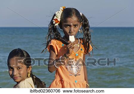 "Two girls eating icecream at the beach of Pondicherry, India, Asia" View Large Photo Image Stock Photograph - "Two girls eating icecream at the beach of Pondicherry, India, Asia". Fotosearch