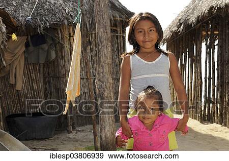 Stock Photo - "Two girls in a Kuna Indian village, Nalunega, San Blas Islands, Panama, North America". Fotosearch