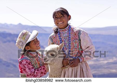 "Two girls in traditional dress with an alpaca, near Arequipa, Peru, South America" View Large Photo Image Stock Image - "Two girls in traditional dress with an alpaca, near Arequipa, Peru, South America". Fotosearch