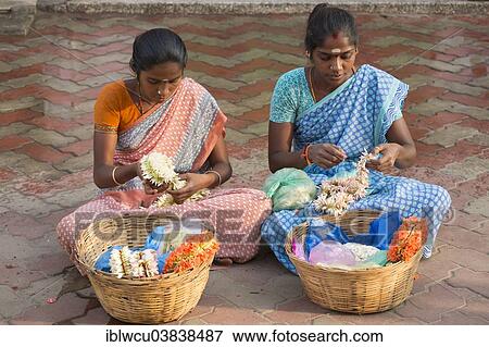 "Two girls producing floral decorations to sell them later, Madurai, Tamil Nadu, India, Asia" View Large Photo Image Stock Photo - "Two girls producing floral decorations to sell them later, Madurai, Tamil Nadu, India, Asia". Fotosearch