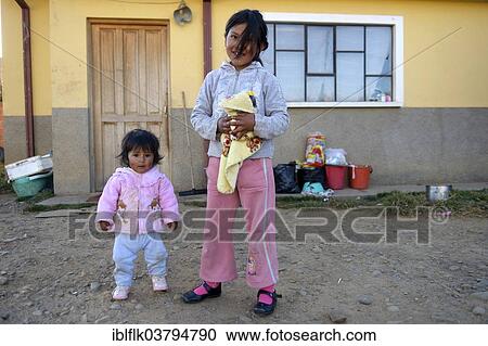 "Two girls standing in front of a house, El Alto, Department of La Paz, Bolivia, South America" View Large Photo Image Stock Image - "Two girls standing in front of a house, El Alto, Department of La Paz, Bolivia, South America". Fotosearch