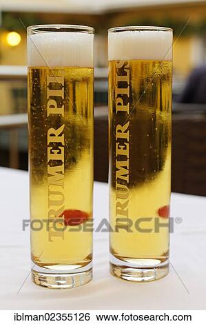Stock Photograph - "Two glasses of beer labelled Trumer Pils, from Salzburg, Grein, Upper Austria, Austria, Europe". Fotosearch