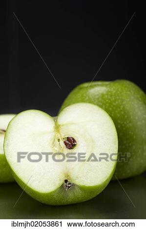 "Two green Granny Smith apples, one cut open" View Large Photo Image Stock Image - "Two green Granny Smith apples, one cut open". Fotosearch