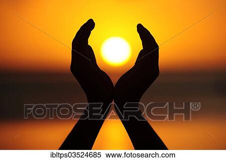 "Two hands holding the setting sun, La Gaulette, Mauritius, Africa" View Large Photo Image Stock Photography - "Two hands holding the setting sun, La Gaulette, Mauritius, Africa". Fotosearch