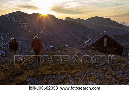 "Two hikers at Edelweisserhuette refuge at sunset, Tennengebirge, Pongau, Salzburg state, Austria, Europe" View Large Photo Image Stock Photo - "Two hikers at Edelweisserhuette refuge at sunset, Tennengebirge, Pongau, Salzburg state, Austria, Europe". Fotosearch