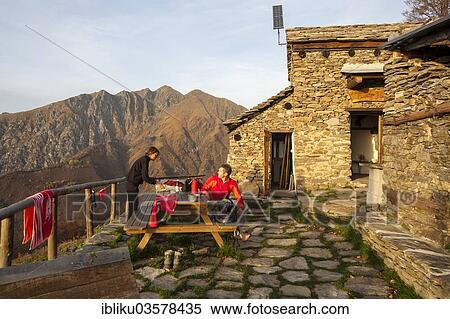 "Two hikers at the Bivacco Alpe Curgei mountain hut, Val Grande National Park, Verbano-Cusio-Ossola province, Piedmont, Italy, Europe" View Large Photo Image Stock Photography - "Two hikers at the Bivacco Alpe Curgei mountain hut, Val Grande National Park, Verbano-Cusio-Ossola province, Piedmont, Italy, Europe". Fotosearch