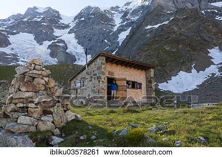 "Two hikers at the Schmadrihuette mountain hut, in front of Gletscherhorn and Mittagshorn mountains, Lauterbrunnental, Canton of Bern, Switzerland, Europe" View Large Photo Image Stock Image - "Two hikers at the Schmadrihuette mountain hut, in front of Gletscherhorn and Mittagshorn mountains, Lauterbrunnental, Canton of Bern, Switzerland, Europe". Fotosearch
