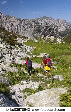 "Two hikers heading towards the Rifugio Garelli mountain hut, Alta Valle Pesio e Tanaro Regional Park, Cuneo province, Piedmont, Italy, Europe" View Large Photo Image Stock Image - "Two hikers heading towards the Rifugio Garelli mountain hut, Alta Valle Pesio e Tanaro Regional Park, Cuneo province, Piedmont, Italy, Europe". Fotosearch
