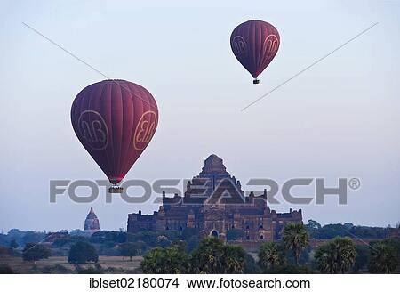"Two hot-air balloons at sunrise over an ancient temple in Bagan, Myanmar, Burma, Southeast Asia, Asia" View Large Photo Image Picture - "Two hot-air balloons at sunrise over an ancient temple in Bagan, Myanmar, Burma, Southeast Asia, Asia". Fotosearch