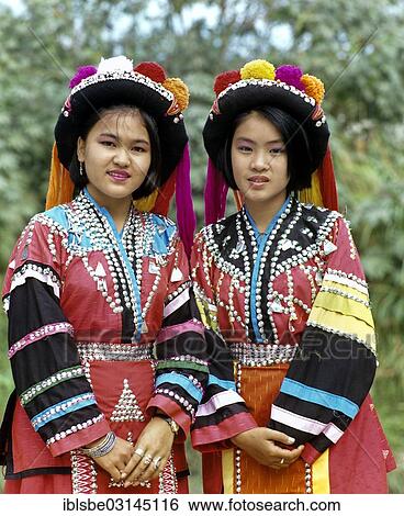 "Two Lisu girls wearing colourful headdresses and the traditional costume of the mountain people, Mae Sai, Chiang Rai Province, Northern Thailand, Thailand, Asia" View Large Photo Image Stock Photograph - "Two Lisu girls wearing colourful headdresses and the traditional costume of the mountain people, Mae Sai, Chiang Rai Province, Northern Thailand, Thailand, Asia". Fotosearch