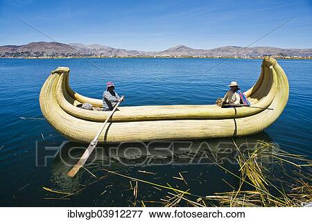 Stock Photo - "Two local in a traditional rowing boat of Totora reed on Lake Titicaca, Peru, South America". Fotosearch