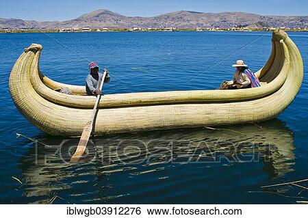 Stock Photograph - "Two local in a traditional rowing boat of Totora reed on Lake Titicaca, Peru, South America". Fotosearch