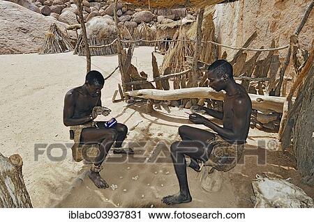 "Two local men rolling cigarettes, Damara Living Museum, near Twyfelfontein, Namibia, Africa" View Large Photo Image Stock Image - "Two local men rolling cigarettes, Damara Living Museum, near Twyfelfontein, Namibia, Africa". Fotosearch