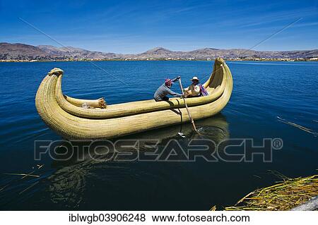 "Two local people rowing a traditional boat made of totora reeds on Lake Titicaca, Southern Peru, Peru, South America" View Large Photo Image Stock Photo - "Two local people rowing a traditional boat made of totora reeds on Lake Titicaca, Southern Peru, Peru, South America". Fotosearch