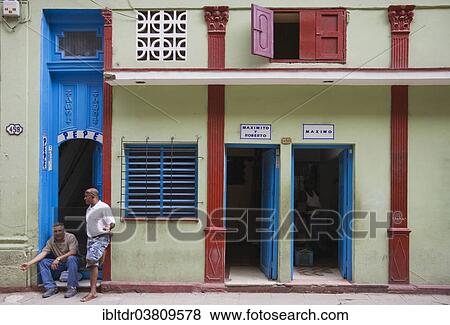 "Two man hanging around at the entrance of a building, Old Havana, Havana, Cuba, North America" View Large Photo Image Stock Photo - "Two man hanging around at the entrance of a building, Old Havana, Havana, Cuba, North America". Fotosearch