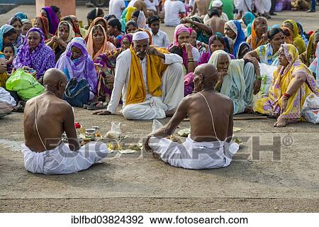 "Two men and a pandit or priest are performing Dashkriya or Asthi Visarjan, a ritual which is performed 10 days after the death of a family member, Nasik, Maharashtra, India, Asia" View Large Photo Image Stock Image - "Two men and a pandit or priest are performing Dashkriya or Asthi Visarjan, a ritual which is performed 10 days after the death of a family member, Nasik, Maharashtra, India, Asia". Fotosearch