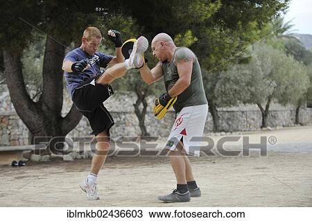 Two men doing martial arts in a park View Large Photo Image Stock Image - Two men doing martial arts in a park. Fotosearch