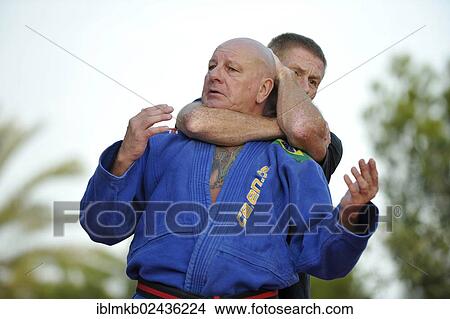 Two men doing martial arts training in a park View Large Photo Image Picture - Two men doing martial arts training in a park. Fotosearch