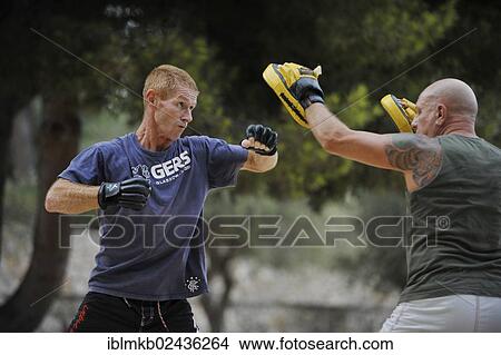 Picture - Two men doing martial arts training in a park. Fotosearch
